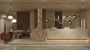 a lobby with a reception desk and a chair and lights at Themis Beach Hotel in Kokkini Khanion