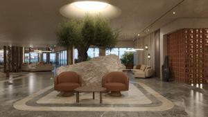 a lobby with a couch and two chairs and a table at Themis Beach Hotel in Kokkíni Khánion +73 photos