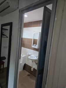 a bathroom with a sink and a toilet and a mirror at Villa Ilham in Langkawi Intl +16 photos