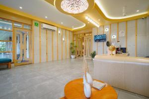 a lobby with a waiting room with a table at Hotel Saubhagya in Ahmedabad