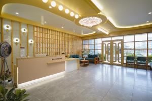 a lobby with a reception desk in a building at Hotel Saubhagya in Ahmedabad