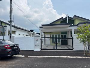 a car parked in front of a house at Amoura Stay in Chemor