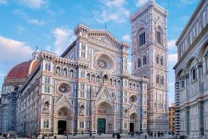 a large building with a clock tower in a city at Firenze Center - 9' to Duomo & Uffizi - AC, Wifi in Florence