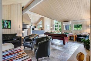 a living room with a pool table and chairs at HS013-Oksbol-Hybenvangen-6 in Oksbøl