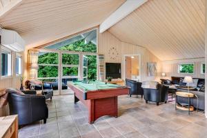 a living room with a pool table and chairs at HS013-Oksbol-Hybenvangen-6 in Oksbøl