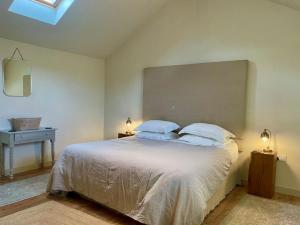 a bedroom with a large white bed with two pillows at 1 Bed in Ullswater 94068 in Watermillock