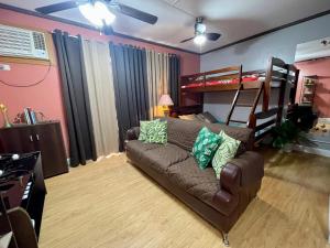 a living room with a couch and a bunk bed at Arezzo Place Condominium in Davao City