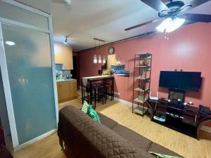 a living room with a couch and a dining room at Arezzo Place Condominium in Davao City