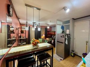 a kitchen with a counter and a refrigerator at Arezzo Place Condominium in Davao City