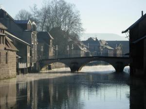 a bridge over a river in a city at La Table de Gustave in Ornans