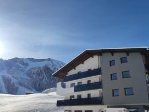 a building on top of a snow covered mountain at Berwang 1336 Apartments in Berwang