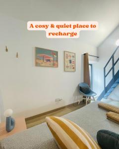 a bedroom with a bed and a blue chair at Cocon Familial Proche Disneyland Paris in Quincy-Voisins