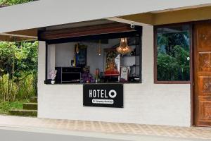 a restaurant with a sign on the side of a building at Hotel O Ranka Gangtok in Tādong