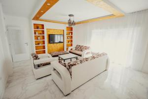 a living room with two couches and a tv at Villa Deluxe Buna in Mostar