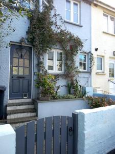 a blue front door of a house with plants at Small cottage in Stratton, Bude in Stratton