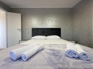 a bedroom with a bed with two towels on it at Villa Deluxe Buna in Mostar +25 photos