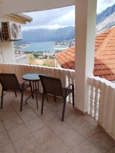 a balcony with a table and chairs and a view at Apartman Tamara i Tijana in Škaljari