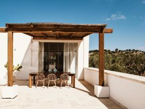 a patio with two chairs and a table on a roof at Boutique B&B Villa Gufo in Ostuni