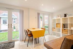a dining room with a table and chairs at Skylight Studio near Hospital in Gaywood