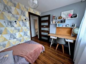 una camera da letto con una scrivania, un letto e un tavolo di Dom w Kryspinowie a Kryspinow