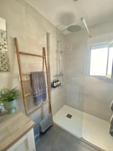 a bathroom with a shower with a glass door at La Luz in Zuheros +23 photos