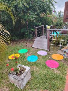 a garden with colorful rang mats on the grass at LE DIAMANT Charmante Villa pour la famille ou entre amis SPA et Piscine in Le Diamant