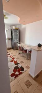 a kitchen with a table and a kitchen with a table and chairs at Apartament in Rădăuţi