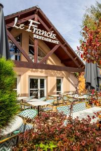 a restaurant with tables and chairs in front of a building at ibis Styles Chartres Sud Barjouville in Chartres