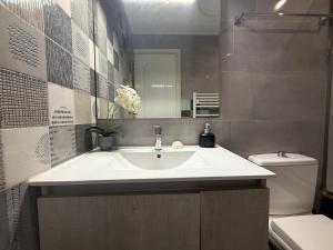 a bathroom with a sink and a toilet at Anna's Seaside Apartment - In front of the beach in Kos Town +15 photos