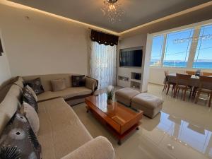 a living room with a couch and a table at Anna's Seaside Apartment - In front of the beach in Kos Town