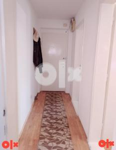 a small hallway with a room with white walls and a rug at Apartman Čeliković in Bosanski Šamac +2 photos