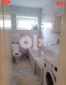 a bathroom with a tub and a toilet and a sink at Apartman Čeliković in Bosanski Šamac