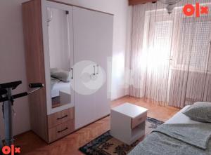 a bedroom with a large mirror and a bed at Apartman Čeliković in Bosanski Šamac