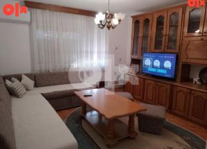 a living room with a couch and a tv at Apartman Čeliković in Bosanski Šamac