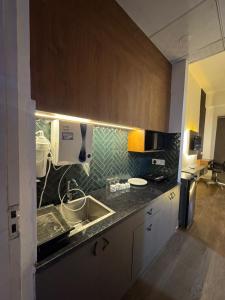a kitchen with a sink and a counter top at Heavenly stays in Greater Noida