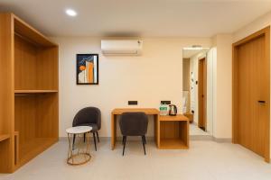 a room with a table and chairs in a room at Hotel Rajshree Suites in Ujjain