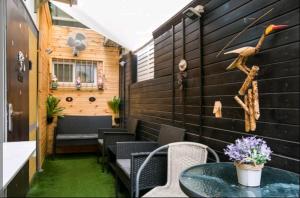 a patio with a table and chairs and a wall at Paradise in haifa near the bahai gardens in Haifa