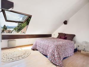 a bedroom with a bed and a large window at Duplex face au lac d'Annecy in Veyrier-du-Lac
