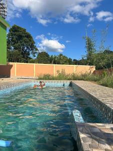 a person swimming in a swimming pool at Ri Tngen - A slice of nature by the Umiam lake! in Borpāni