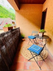 a patio with two chairs and a table on a balcony at Duplex face au lac d'Annecy in Veyrier-du-Lac