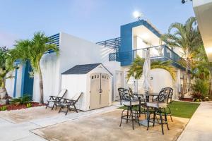 a patio with a table and chairs in front of a building at Aquaville Dorado Moderna Villa 3 in Dorado