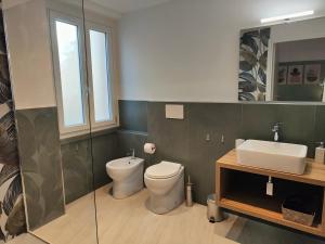 a bathroom with a toilet and a sink at Casa Nanni in Genova +17 photos