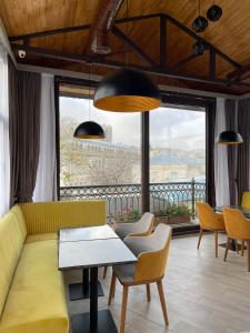 a living room with a yellow couch and chairs at Seven Beauties Hotel Spa Restaurant in Baku +126 photos
