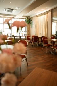 a dining room with tables and chairs and tablesearcher at Klub Sosnowy in Warsaw