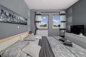 a bedroom with two beds and a flat screen tv at Home DiE Paradise in Labin