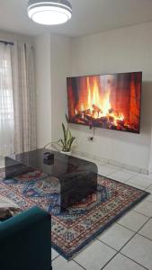 a living room with a fireplace and a coffee table at 18 Key Largo Ocean House of Uzurie in Kingsburgh