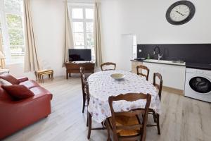 a kitchen and dining room with a table and chairs at Gîte de la Tour in La Celle-sous-Gouzon +9 photos