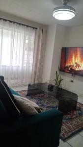 a living room with a couch and a fireplace at 18 Key Largo Ocean House of Uzurie in Kingsburgh +35 photos