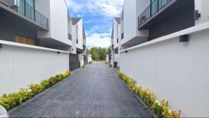 an empty alley between two apartment buildings at Bangtao Brand New Luxury Modern Pool Villa Laguna Phuket in Thalang