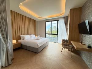 a bedroom with a bed and a large window at Bangtao Brand New Luxury Modern Pool Villa Laguna Phuket in Thalang +22 photos